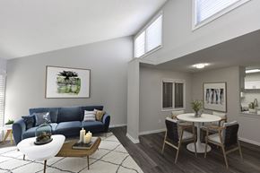 Memphis apartment for rent - a living room with a blue couch and a dining room table