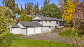 Bothell house for rent - a white house with a driveway in front of it