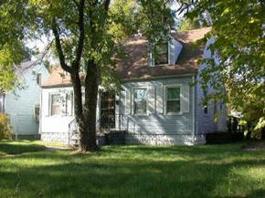 Gary house for rent - a white house with a tree in front of it