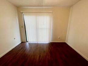 New Albany apartment for rent - A room with a wooden floor and a sliding door.
