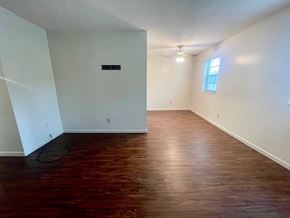 New Albany apartment for rent - A room with wooden flooring and a window.