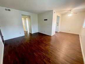 New Albany apartment for rent - A room with wooden flooring and white walls.