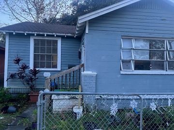 Jacksonville house for rent - a blue house with a fence in front of it