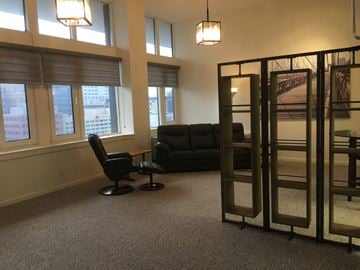 Rochester apartment for rent - a living room with a couch and a chair and some windows