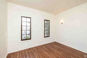 Los Angeles apartment for rent - A room with two windows and wooden floors.