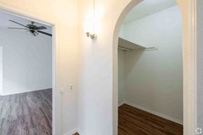 Los Angeles apartment for rent - A room with a ceiling fan and a light fixture on the wall.