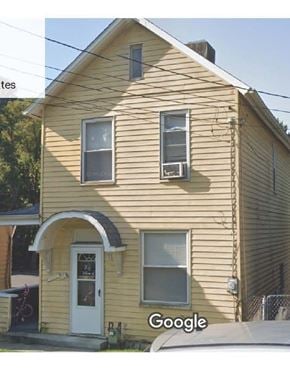 White Oak house for rent - A yellow house with a white door and windows.
