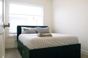 Dawson Creek apartment for rent - a bedroom with a bed and a window