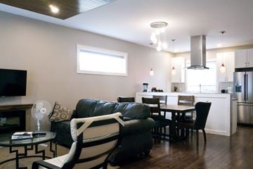 Dawson Creek apartment for rent - a living room with a couch and a table and a kitchen