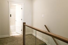 Dawson Creek apartment for rent - a stairway with a railing and a door to a hallway with a white door