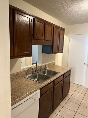 Newnan house for rent - a kitchen with a sink and wooden cabinets