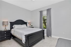 Estero house for rent - the master bedroom has a large bed and a window