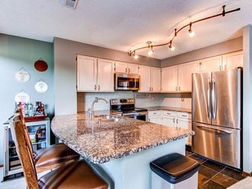 Lakewood house for rent - the kitchen has stainless steel appliances and a granite counter top