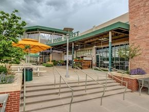 Lakewood house for rent - a patio outside of a building with stairs and umbrellas