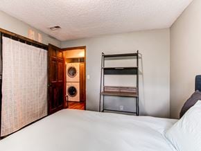 Lakewood house for rent - a bedroom with a bed and a closet and a laundry room