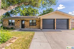 Killeen house for rent - a small brick house with two garage doors
