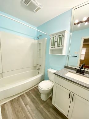 Lafayette house for rent - A white toilet sits in a bathroom with light blue walls.