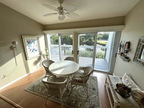Bradenton house for rent - a dining room with a table and chairs and a balcony