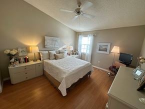 Bradenton house for rent - a bedroom with a bed and a ceiling fan