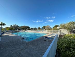 Bradenton house for rent - a resort style swimming pool at the resort on a sunny day