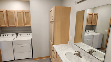 Fargo apartment for rent - a kitchen with white appliances and wooden cabinets and a sink