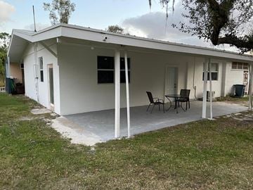Fort Pierce apartment for rent - a house with a patio and a table and chairs on it
