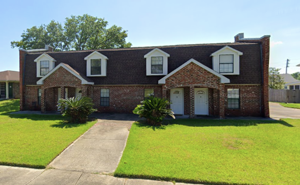 Long Beach apartment for rent - a red brick house with white windows and a lawn