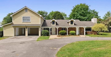 Gulfport apartment for rent - A two-story house with a garage and a driveway.