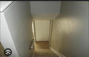 Severn house for rent - the stairway leading up to a white door and stairs