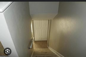 Severn house for rent - a hallway with stairs and a white door      and a door