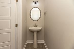 Clarksville house for rent - a small bathroom with a sink and a mirror
