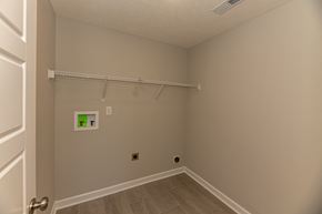 Clarksville house for rent - a bedroom with a hanging rod on the wall and a closet