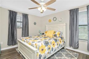 Estero house for rent - a bedroom with a bed and a ceiling fan