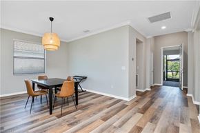Estero house for rent - a dining room with a table and chairs and a door to a hallway