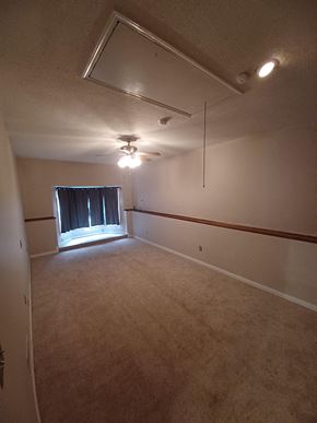 Clarksville house for rent - an empty room with a ceiling fan and a window
