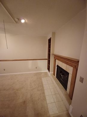 Clarksville house for rent - a living room with a fireplace and a tiled floor