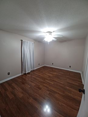 Clarksville house for rent - a living room with wood floors and a ceiling fan