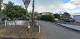Vista apartment for rent - A road with a white fence and a sign on the side.