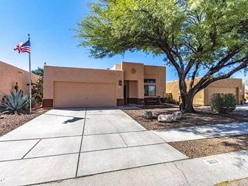 Tucson house for rent - a house with a flag and a tree in front of it