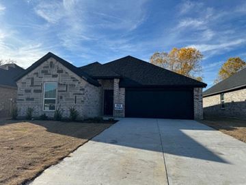 Greenville house for rent - a brick house with a black garage door