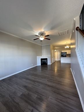 Clarksville house for rent - an empty living room with a ceiling fan and a fireplace