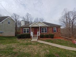 Clarksville house for rent - A house with a red door and a white fence.