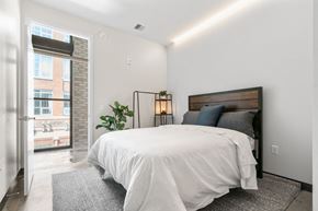 Minneapolis apartment for rent - a bedroom with a bed and a door to a balcony