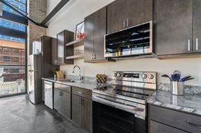 Minneapolis apartment for rent - a kitchen with stainless steel appliances and marble counter tops