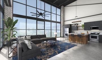 Minneapolis apartment for rent - a living room with a gray couch and a kitchen with a large window