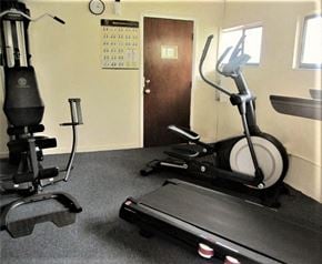 Bradenton house for rent - a gym with exercise equipment in a room with a door