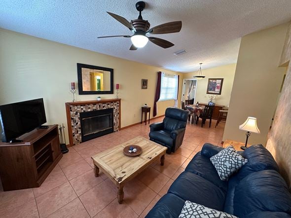 Bradenton house for rent - another view of the living room with a fireplace and a blue couch