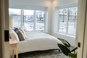 Winnipeg apartment for rent - a bedroom with a bed and three windows
