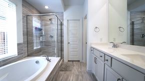 Royse City house for rent - A bathroom with a white tub and a white door.