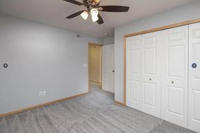 Rochester apartment for rent - a bedroom with a ceiling fan and a closet